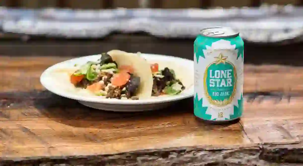 Plate of beef tacos on flour tortillas with a cold Lone Star Rio Jade beer