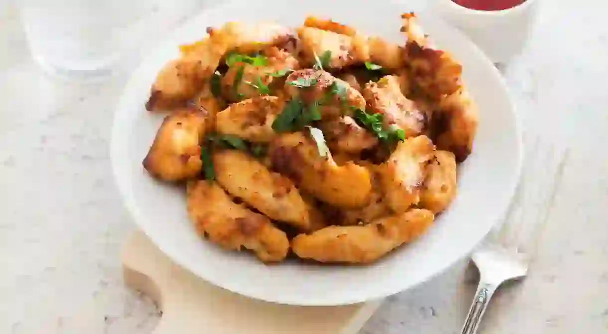 Fried chicken fillet with parsley and ketchup