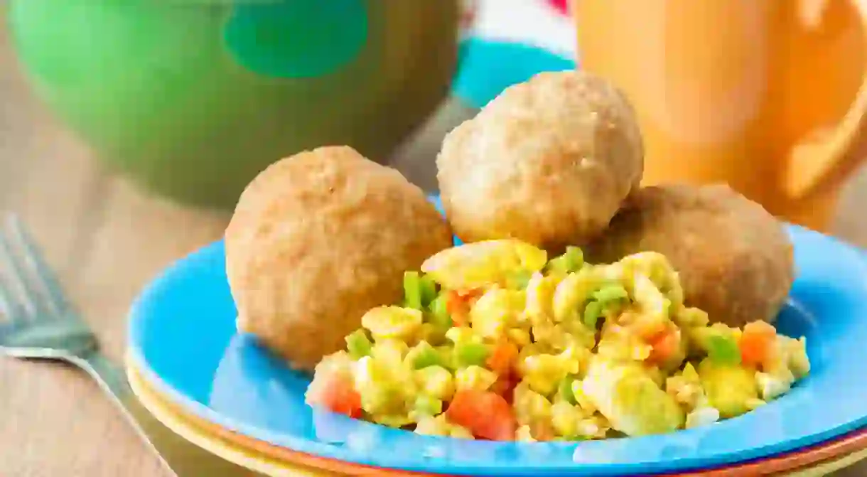 Jamaican ackee and saltfish served with a side of fried dumplings