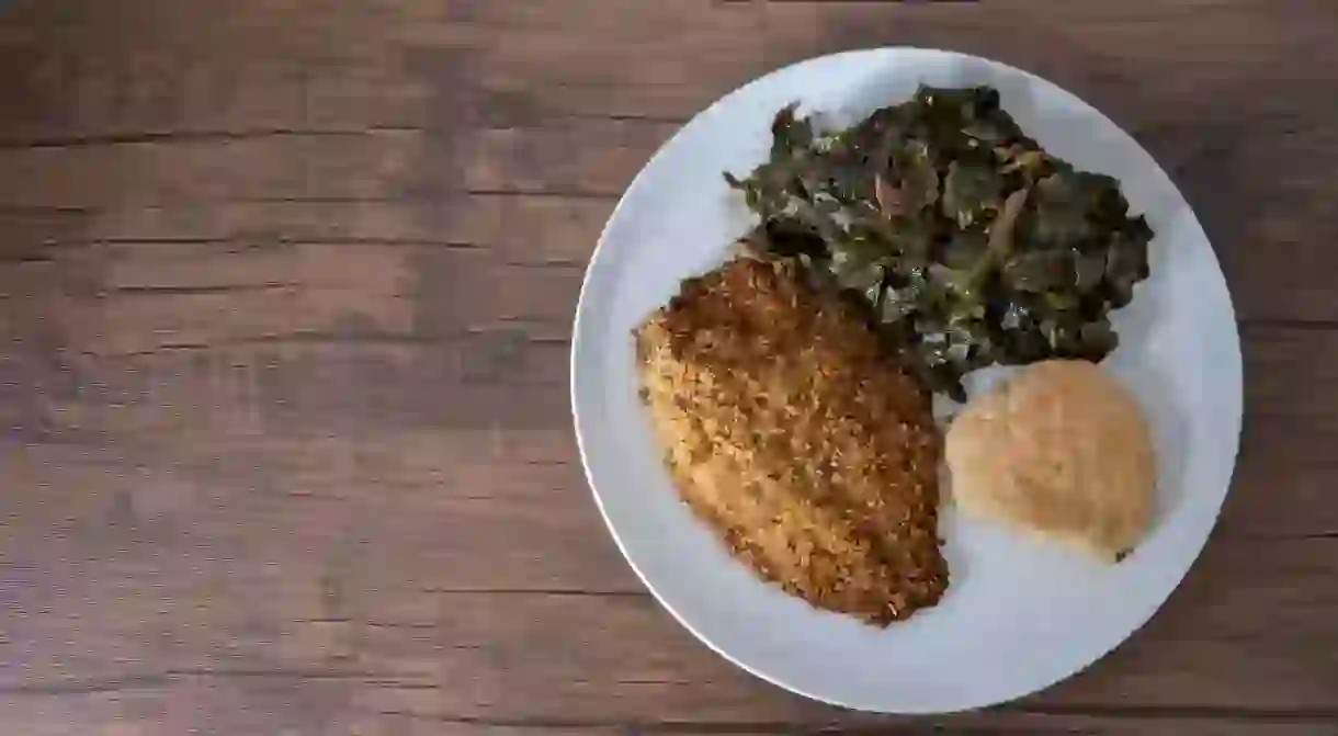 Plate with catfish, collard greens and buttermilk biscuit