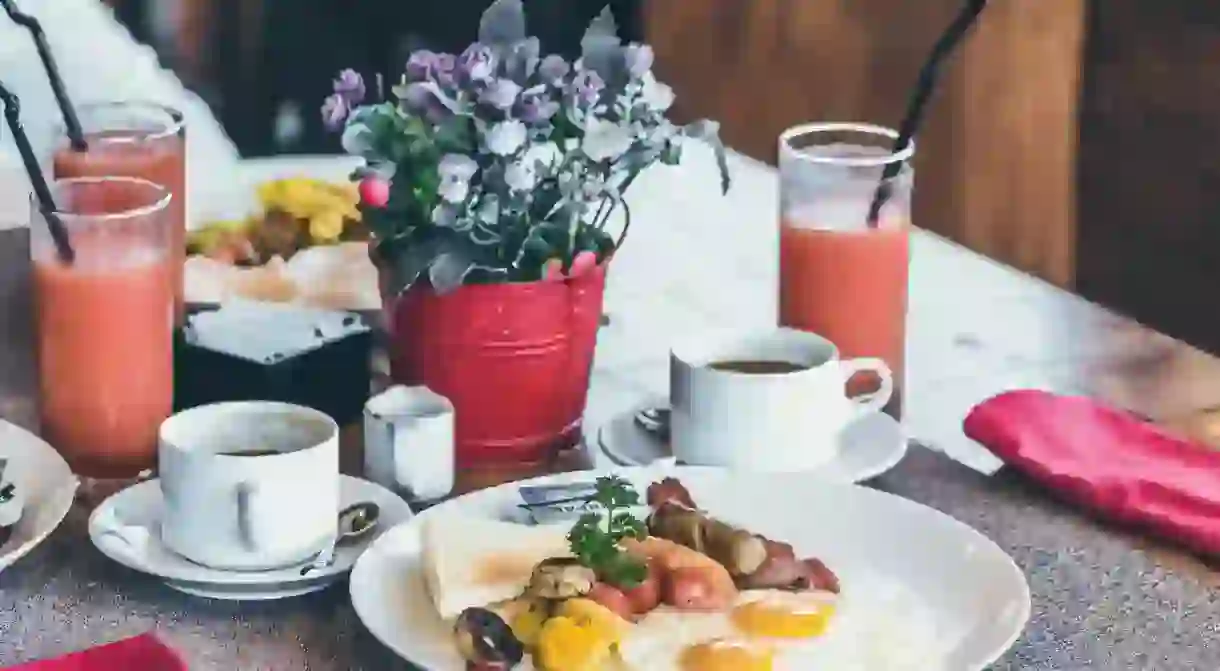 Breakfast with fried eggs, juice, coffee and fruit