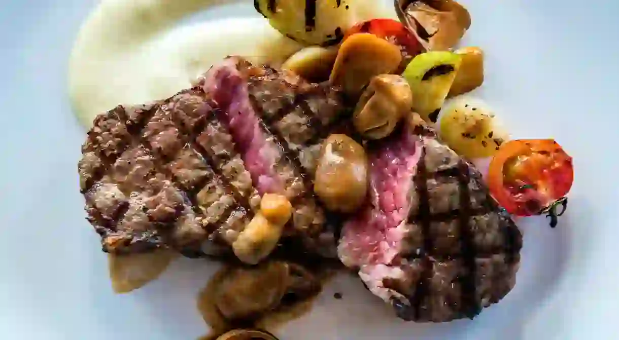 Steak with grilled mushrooms, tomato and potato toppings