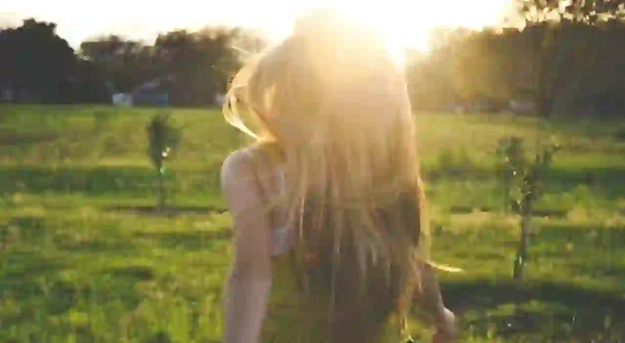 Girl walking in nature in early morning