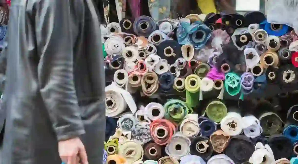 Rolls of textile fabric displayed for sale at Walthamstow market in London