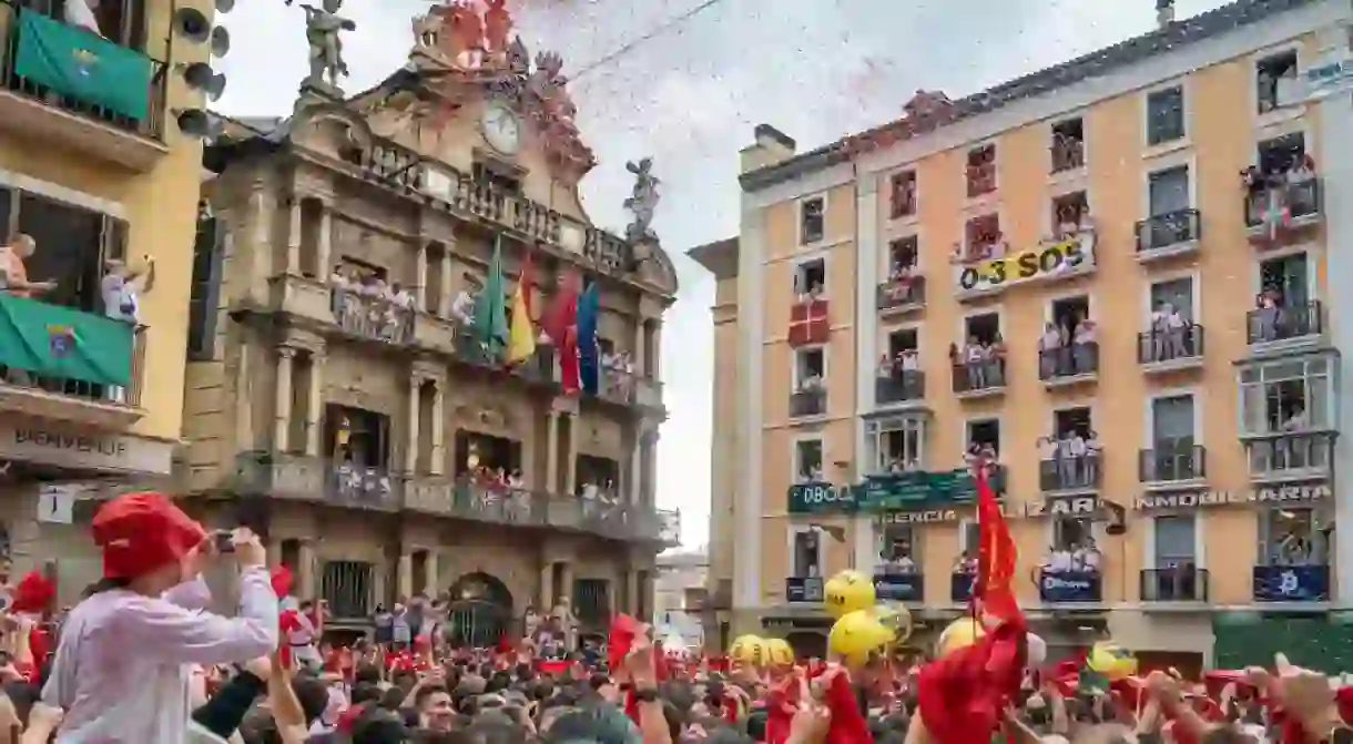 People at the balconies assisting at the San Fermin event in the center of the city in Consistorial Square