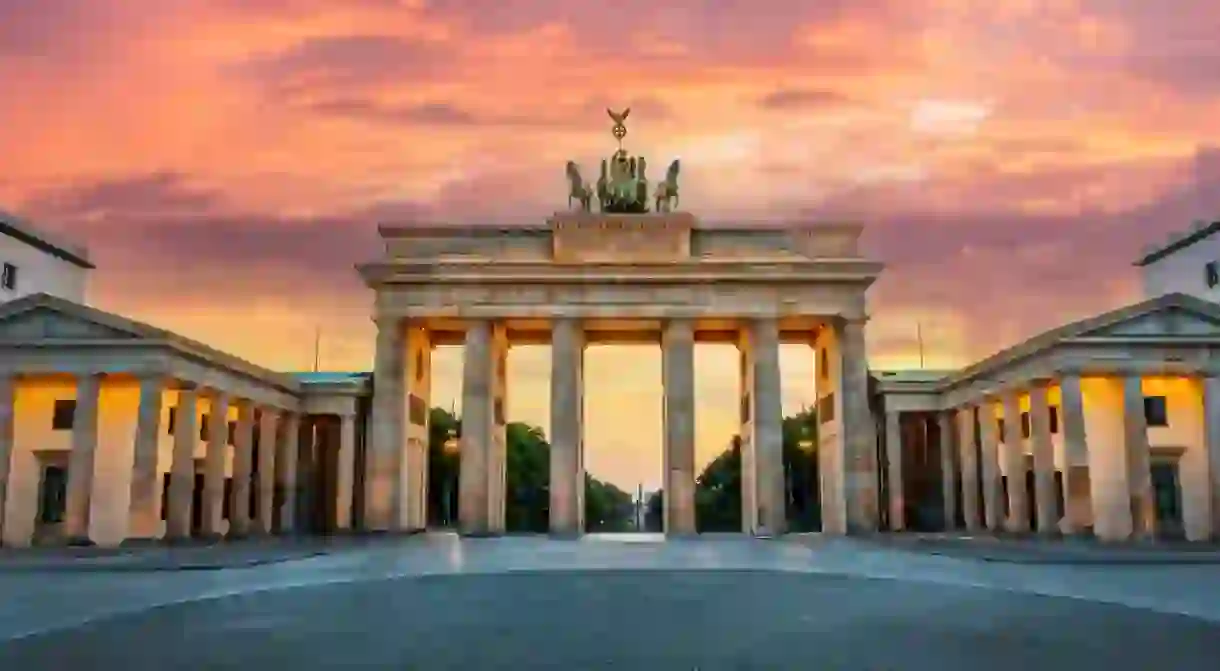 Brandenburg gate illuminated at sunset in Berlin, Germany