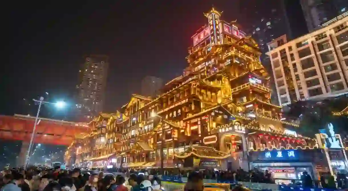 Chongqing, China - Oct 25, 2023; Crowd of tourists taking a photo of the Hongyadong in Chongqing, China