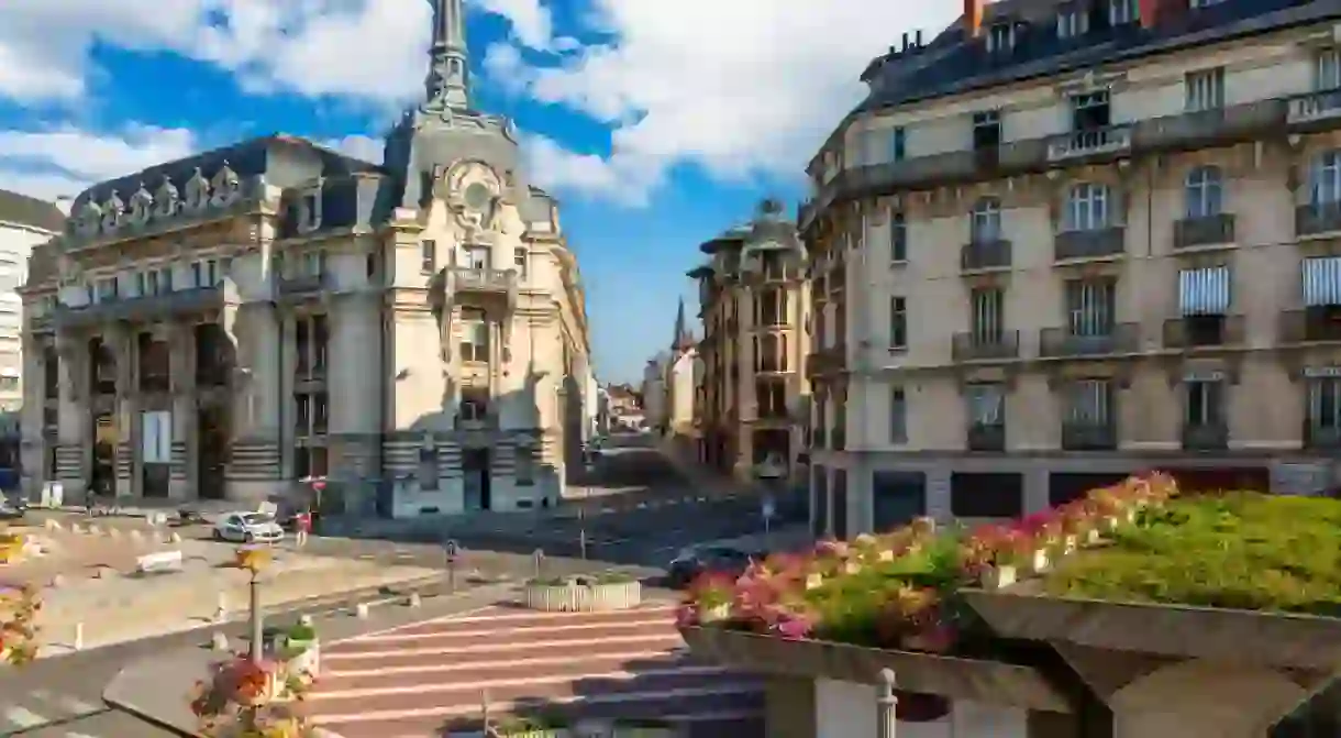 Place Grangier and Temple street in Dijon with the Poste building. Dijon is a city that serves as the prefecture of the Cote-dOr department.