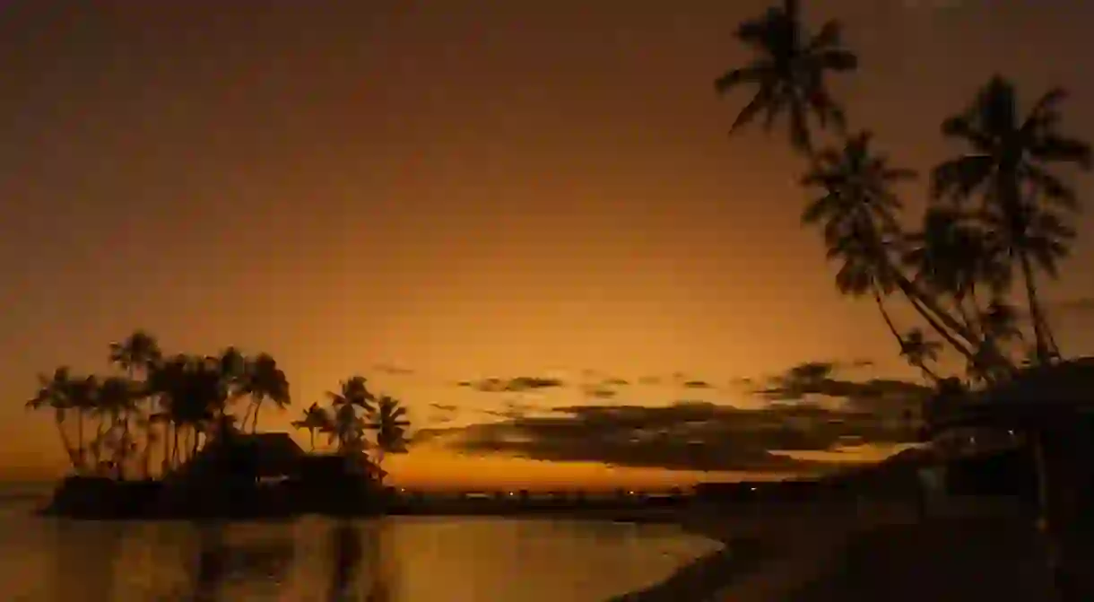 Vacation photos on Fiji Island with gorgeous sunset and silhouettes