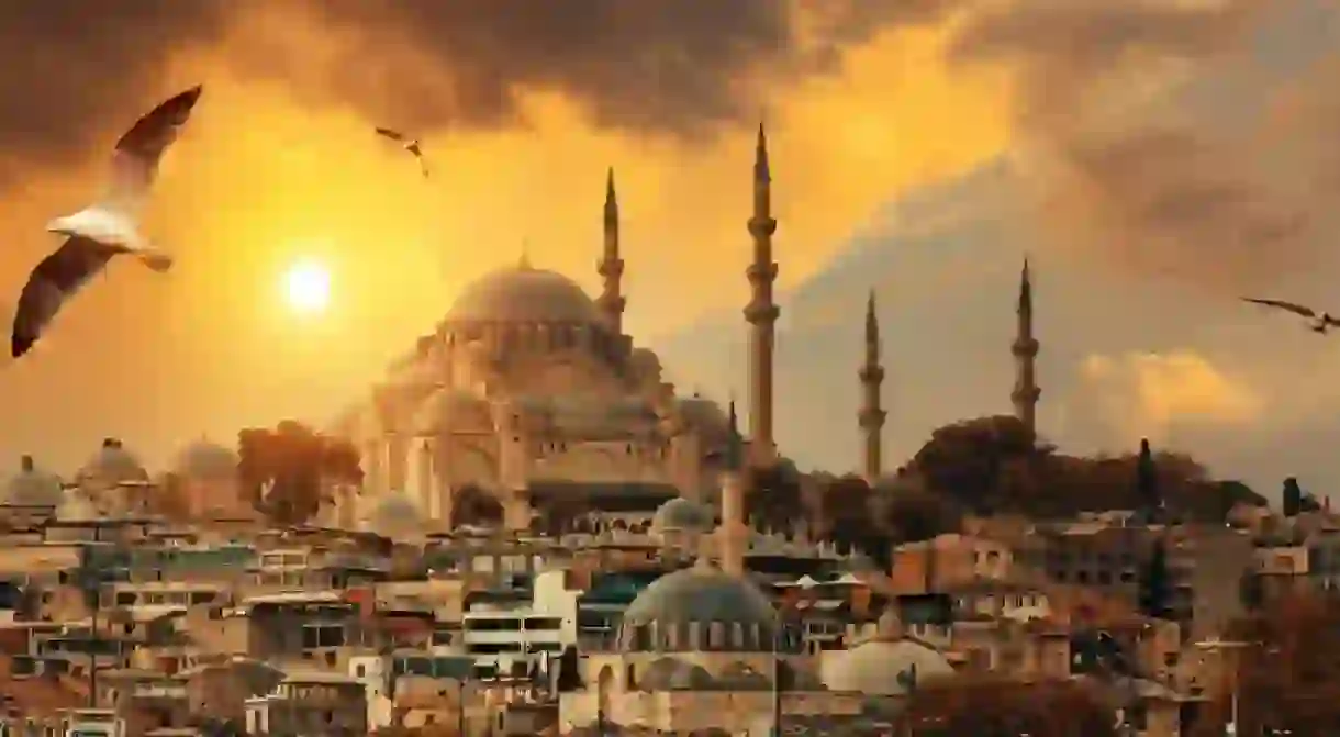 Beautiful view of gorgeous historical Suleymaniye Mosque, Rustem Pasa Mosque and buildings in front of dramatic sunset. Istanbul most popular tourism destination of Turkey. Travel Turkey concept.