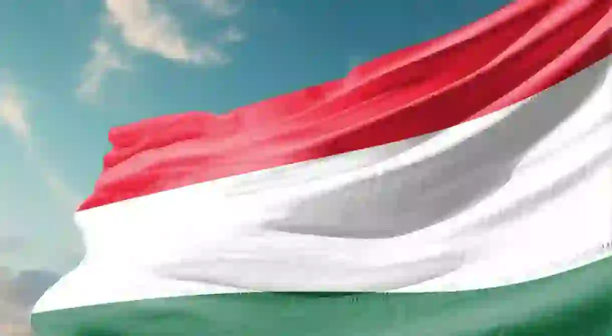 National Flag of Hungary isolated. Hungary flag waving with sky background for independence day.