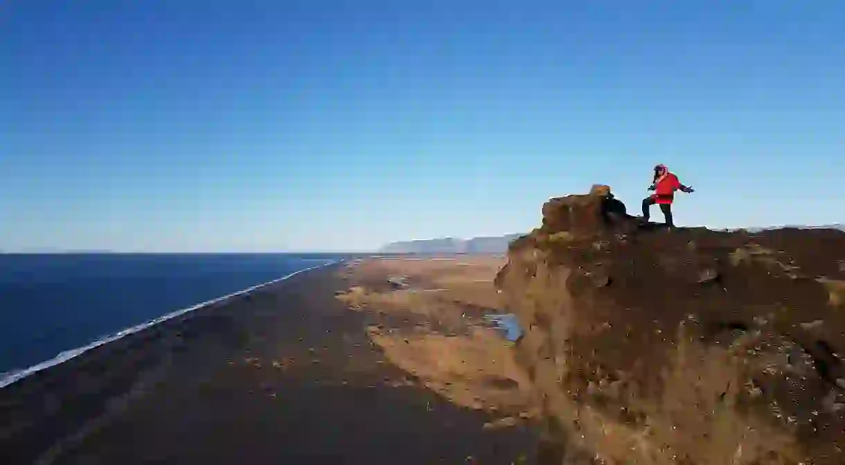 Explore the otherworldly locations like the black sands beach from Icelands capital city