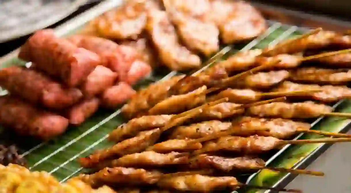 Pork skewers in a street food stall in the city of Bangkok in Thailand.