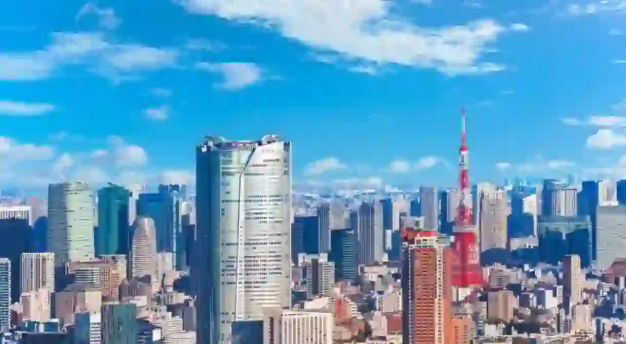 An expansive view capturing a jungle of buildings overseeing the cityscape of Roppongi and Hamamatsucho featuring the striking Roppongi Hills and Tokyo Tower, two landmarks skyscrapers of modern Japan