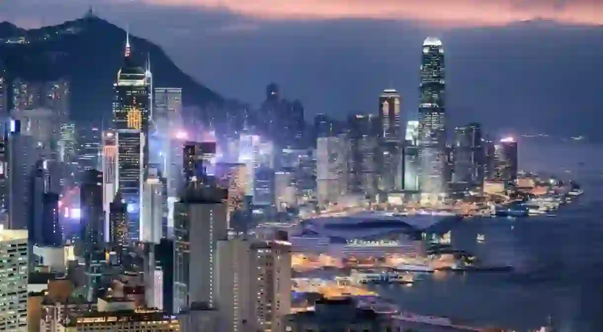 Wonderful aerial view of skyscrapers in downtown of Hong Kong at sunset. Awesome cityscape. Hong Kong is a popular tourist destination of Asia.