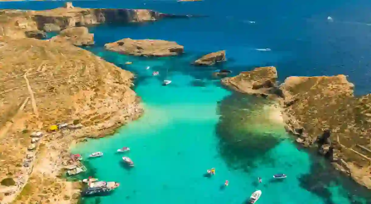 Drone view of boats on the sea, Comino island, Blue lagoon and Crystal lagoon. Malta