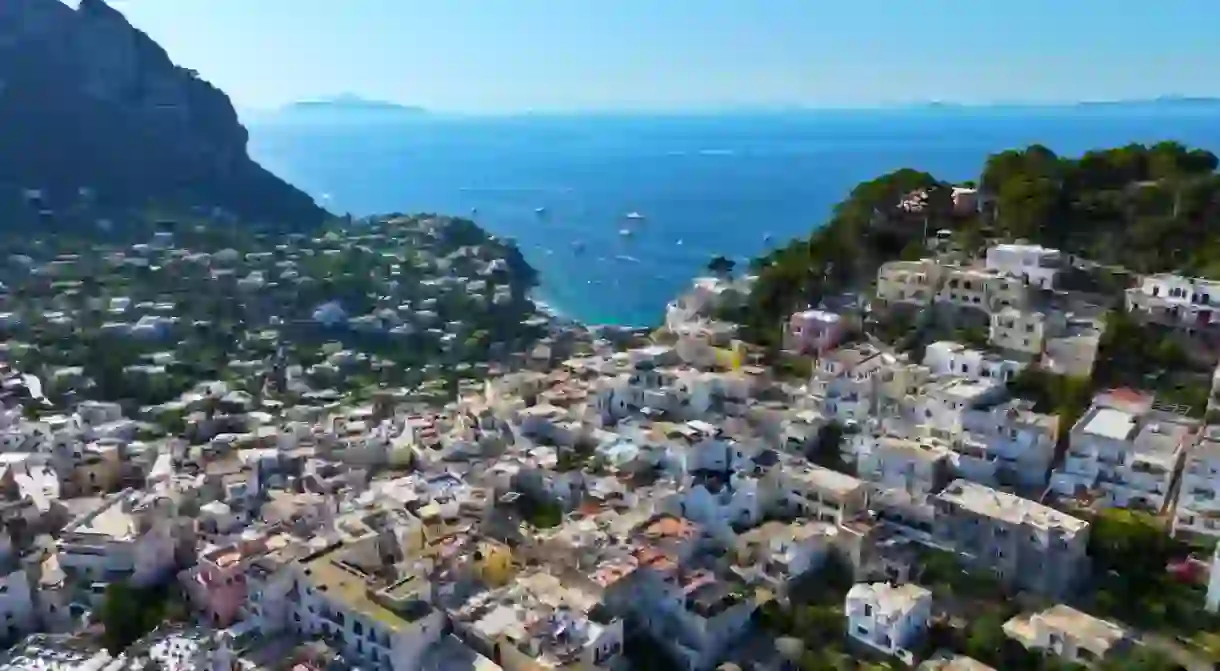 Capri. Amalfi coast. Italy. Incredible colors and views. Drone view. View from above. Buildings and landmarks of Capri. Drone view of boats and yacht. Drone view of Capri. The most beautiful island