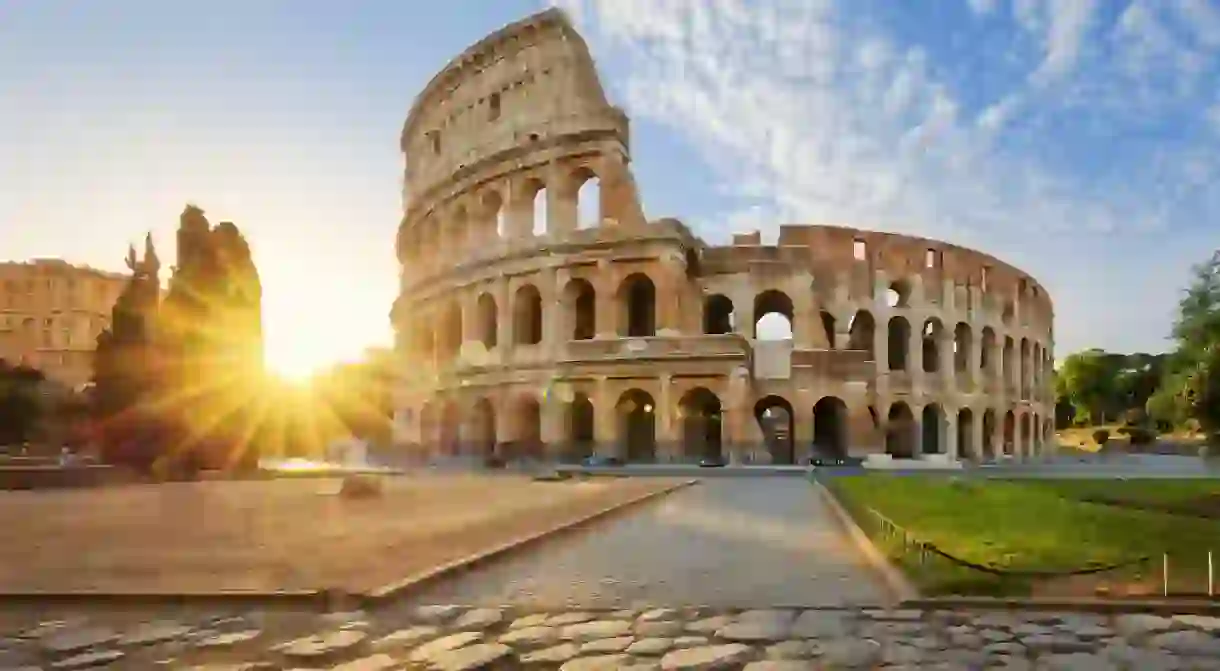 View of Colosseum in Rome and morning sun, Italy, Europe.