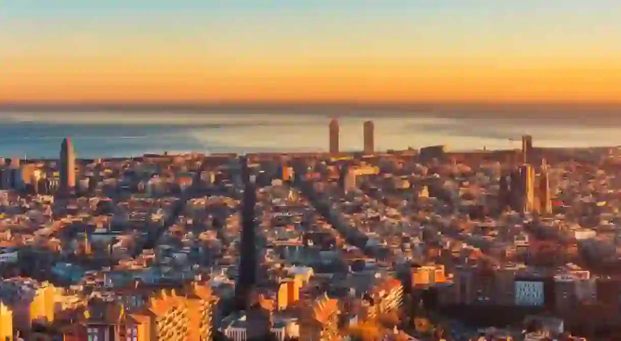 High angle panoramic view over Barcelona Spain and Mediterranean Sea around sunset