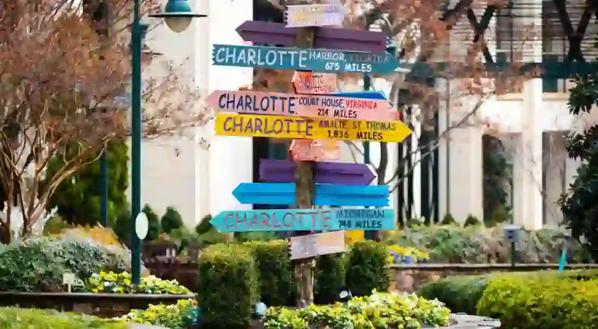 Colorful directions signs in Charlotte The Green city center park at sunny day