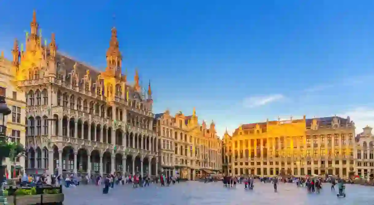 The Grand-Place Grote Markt Big Market square in Brussels city historical center with people, sunset view, Kings House Brussels City Museum, House Dukes Brabant and Guilds of Brussels, Belgium