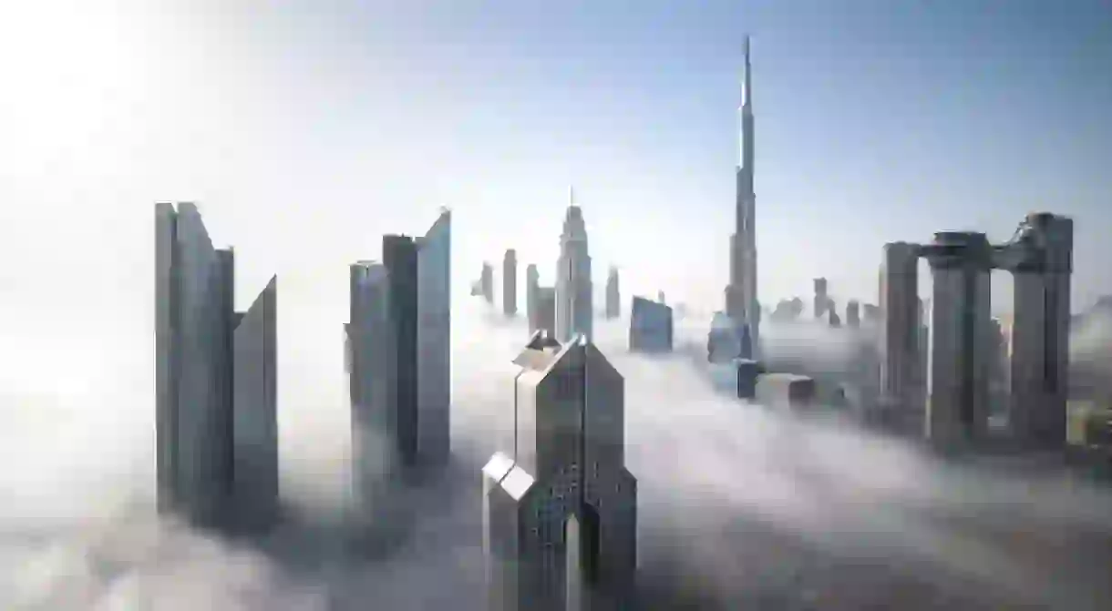 Cityscape of Dubai Downtown skyline on a foggy winter day. Dubai, UAE.