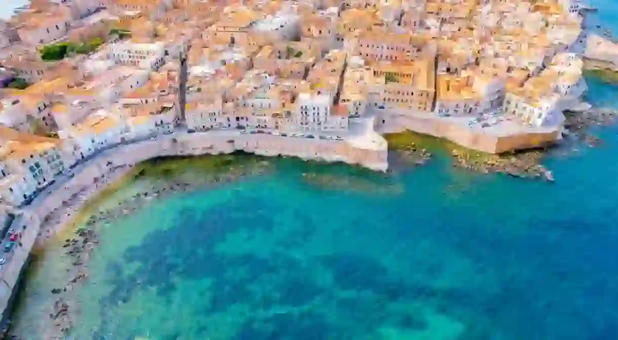 Aerial of Ortigia island, old town with turquoise sea of Syracuse.