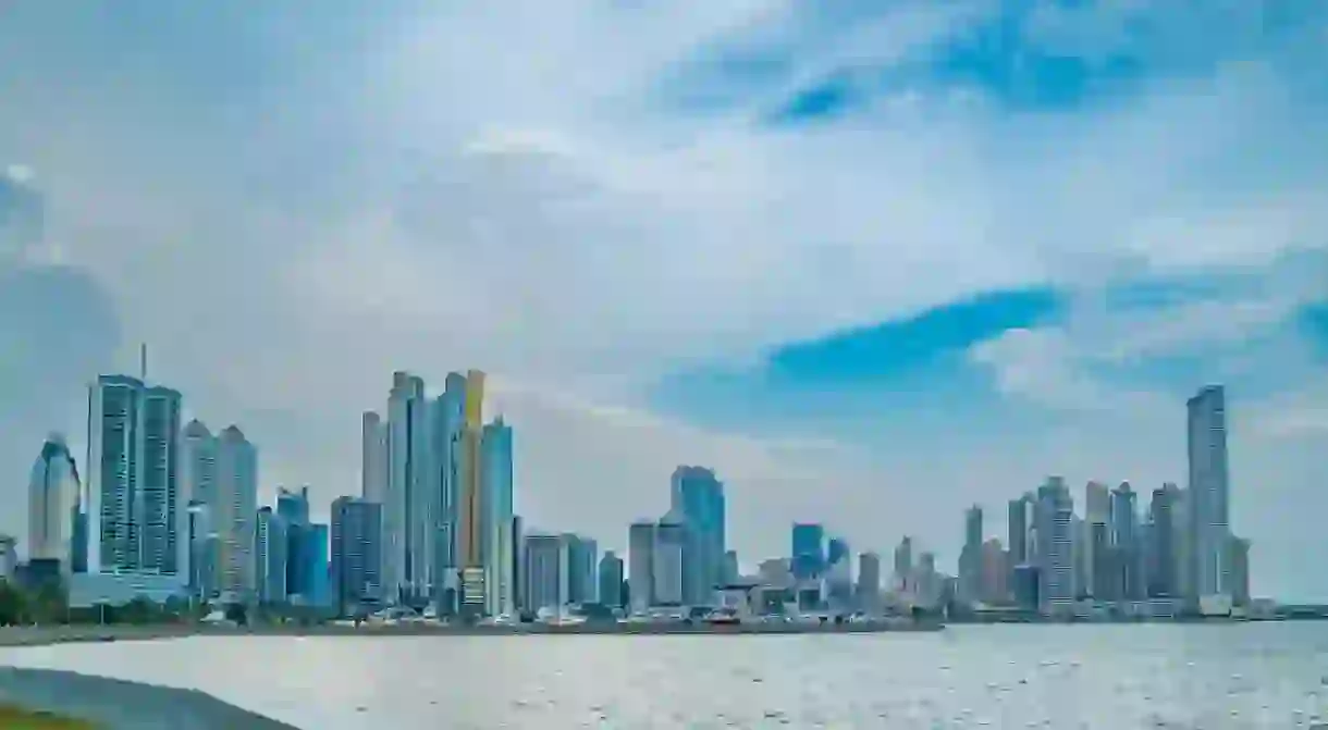 A daytime view of Panama City’s modern skyline seen from a waterfront promenade