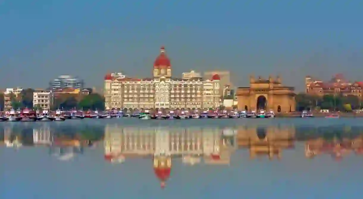 The Gateway of India and boats in the background Taj Mahal Hotel - Mumbai, India