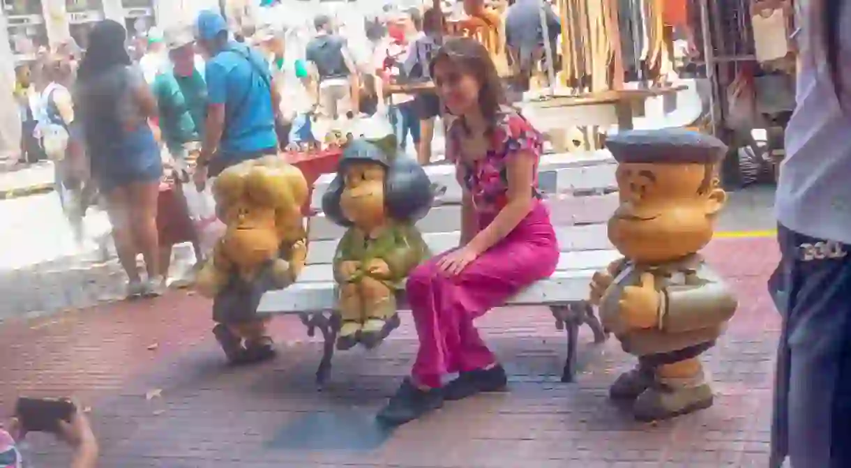 A woman poses with cartoon characters on the Paseo de la Historieta, Buenos Aires