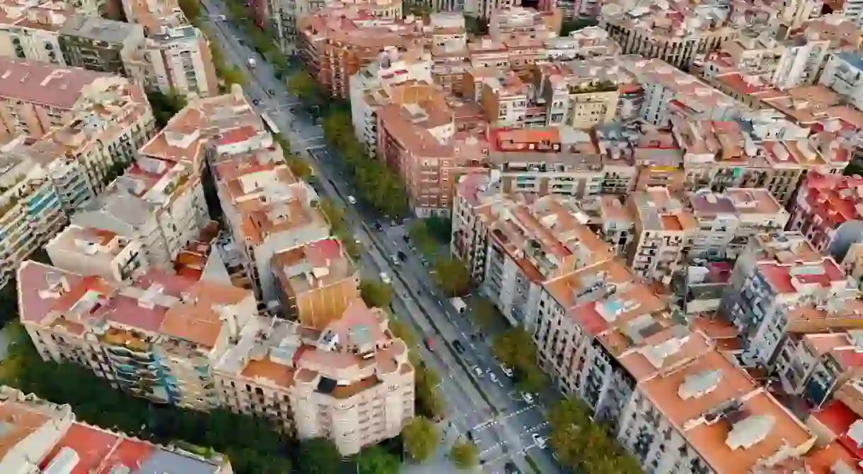 Aerial view of Barcelona City Skyline and Sagrada Familia Cathedral at sunset.