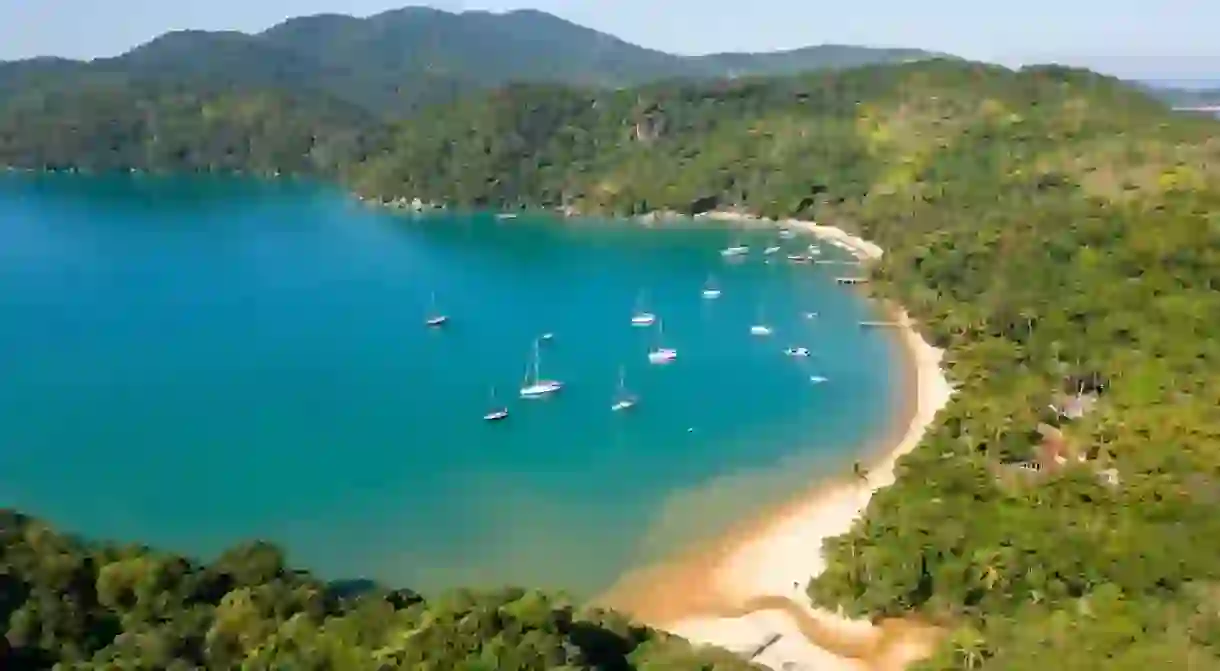 Pouso Beach in Ilha Grande, Rio de Janeiro, Brazil. Beautiful paradise beach with crystal clear waters. Perfect for snorkeling. Drone flight with top view.