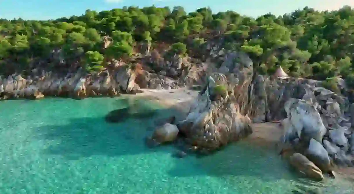 Beautiful orange beach Kavourotripes , Sitonia, Halkidiki, Greece. Aerial shot of lagoon with turquoise water, sandy beach and pine trees