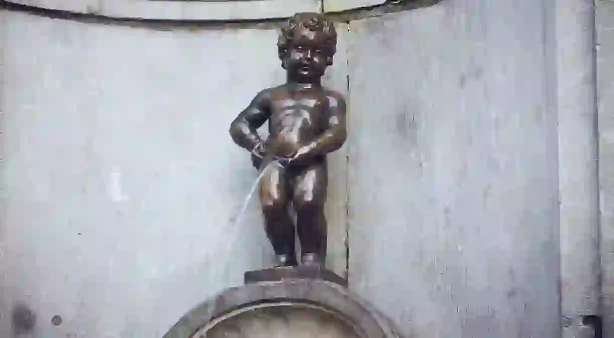 Brussels, Belgium - Manneken Pis close up. Famous Brussels sculpture depicting a urinating boy, cultural landmark, tourist attraction